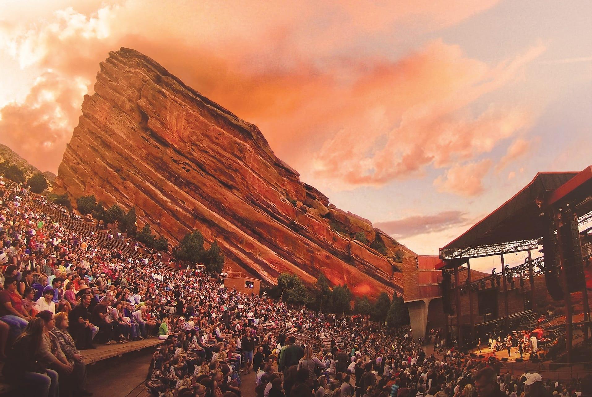 A full audience watching a concert at sunset in the amphitheatre
