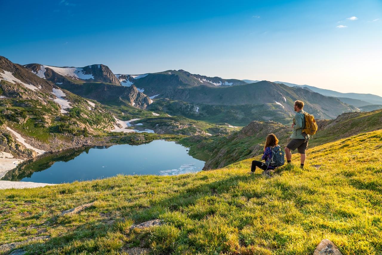 Hikers overlooking an alpine lake